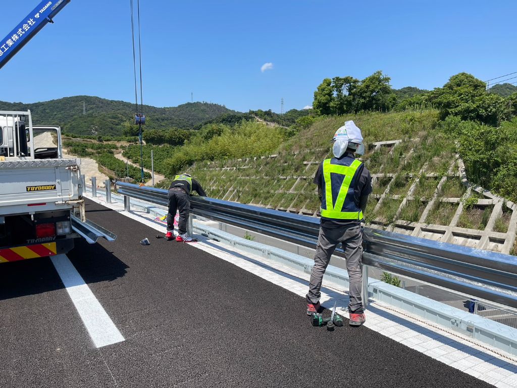 道路でガードレールを設置するニドアの職人